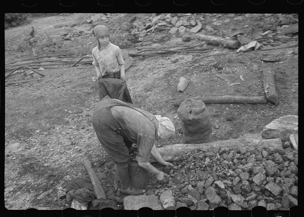 Woman and child picking coal from a slag heap. They are paid ten cents for each 100 pound sack, Nanty Glo, Pennsylvania.…