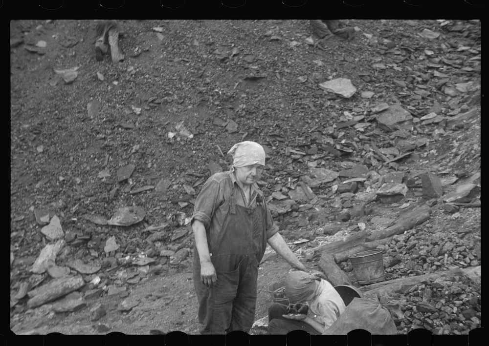 [Untitled photo, possibly related to: Woman and child picking coal from a slag heap. They are paid ten cents for each 100…