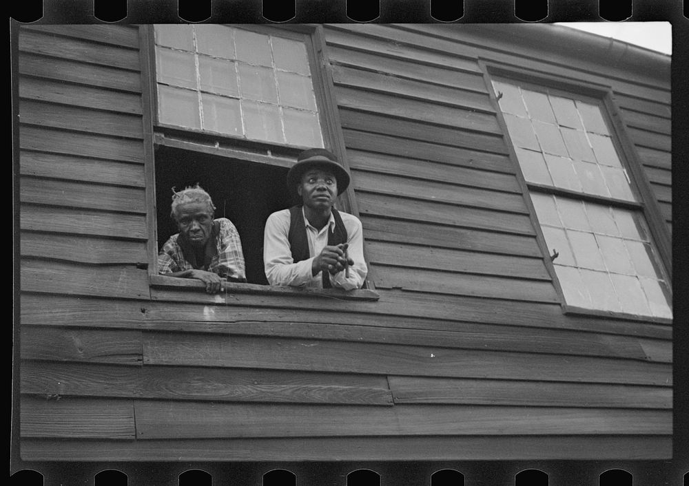  quarter, Natchez, Mississippi. The home of a Negro family with a Negro man and a woman looking out a window. Sourced from…