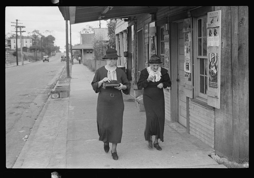 Two women walking along street, Natchez, Mississippi. Sourced from the Library of Congress.