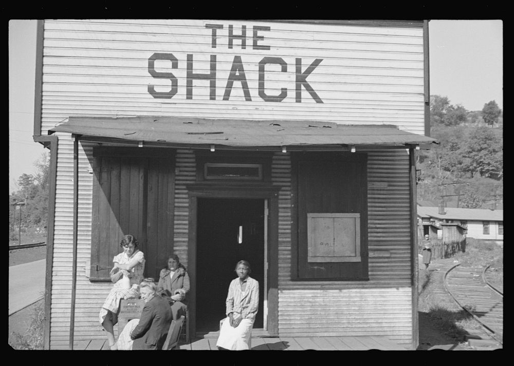[Untitled photo, possibly related to: The Shack, a one time church; milk is dispensed here. Relief clients wait for hours…