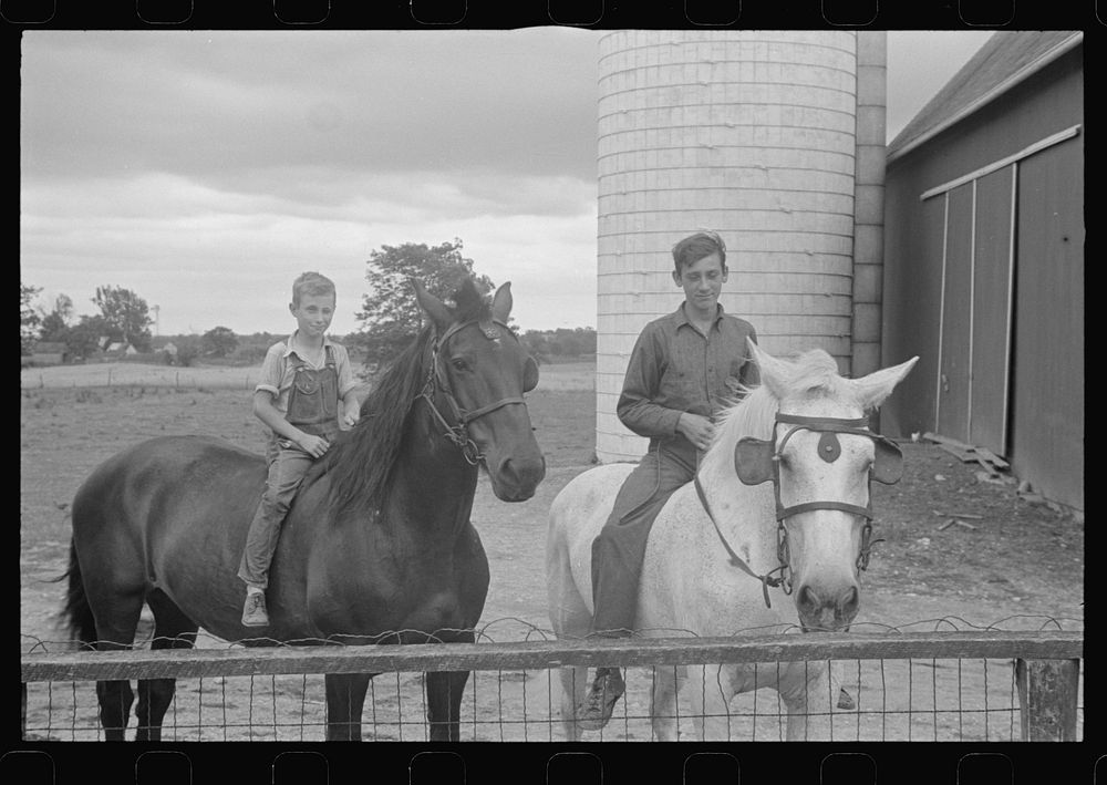 Sons of Mr. Thaxton, farmer, on horseback in farmyard, near Mechanicsburg, Ohio. Sourced from the Library of Congress.
