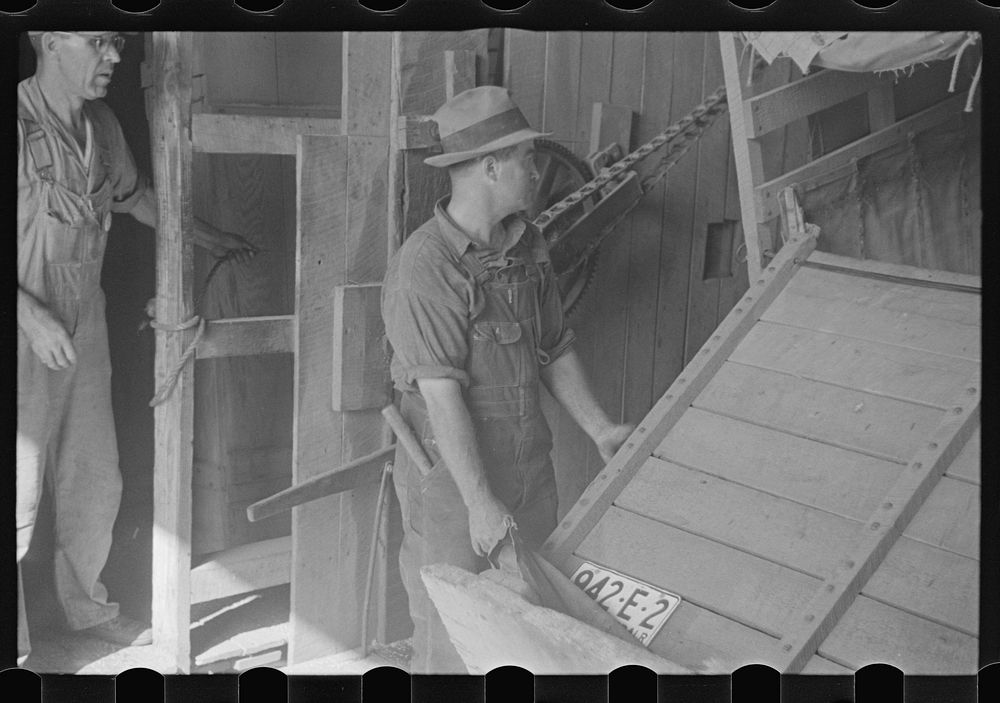 Unloading truck inside grain elevator, Plain City, Ohio. Sourced from the Library of Congress.
