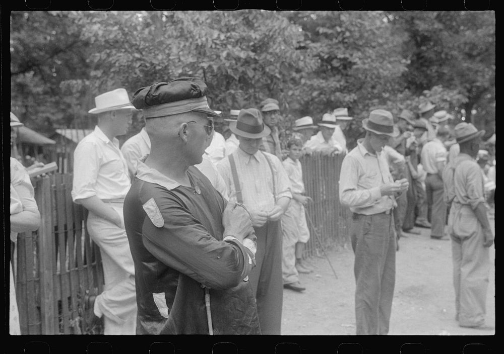 Spectators and clocker at county fair in central Ohio. Sourced from the Library of Congress.