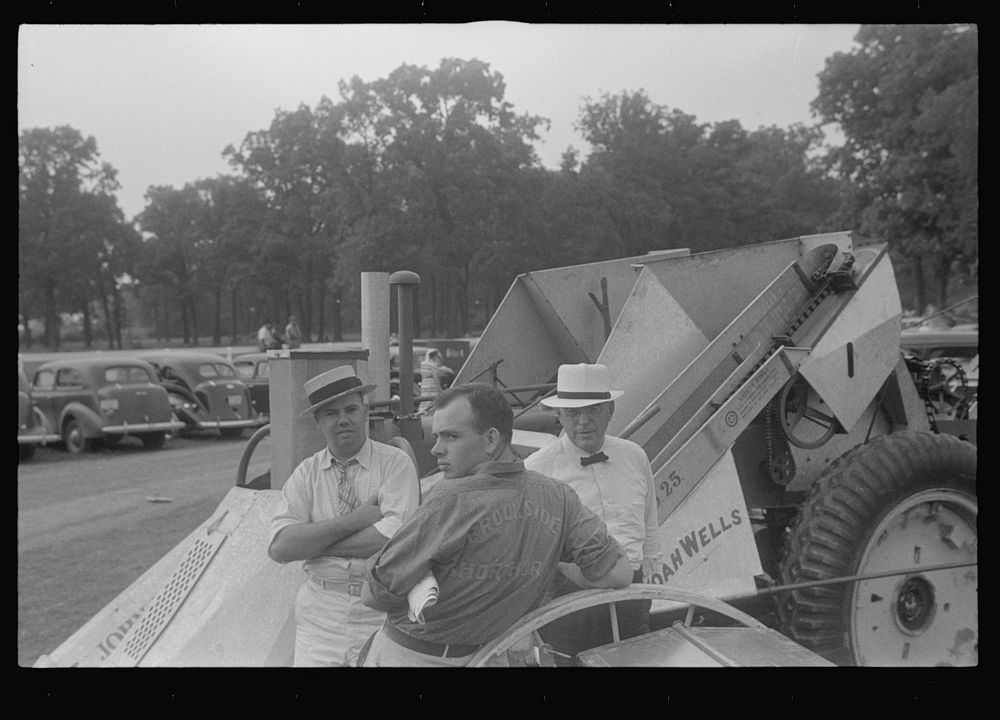 [Untitled photo, possibly related to: Attendant at farm machine display, county fair, central Ohio]. Sourced from the…