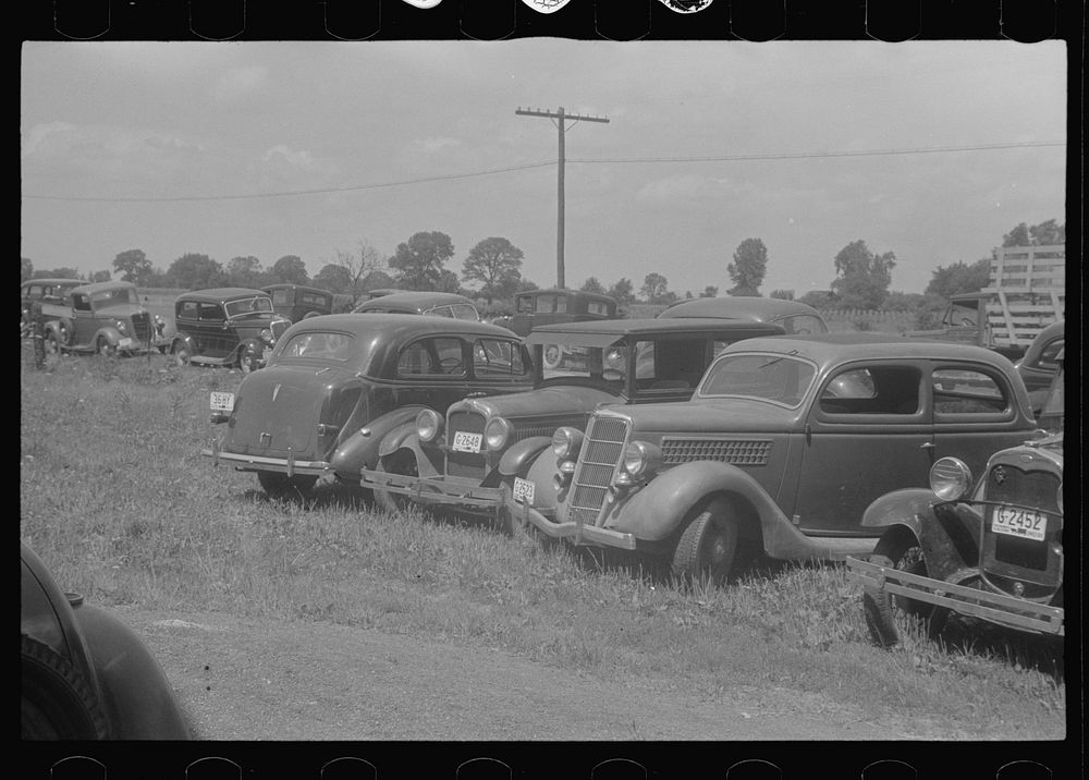 Farmers' cars parked outside of public auction, central Ohio. Sourced from the Library of Congress.