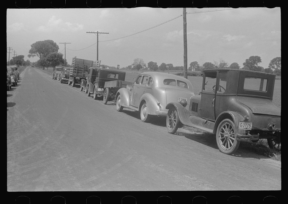Farmers' cars parked along highway near a public auction, central Ohio. Sourced from the Library of Congress.
