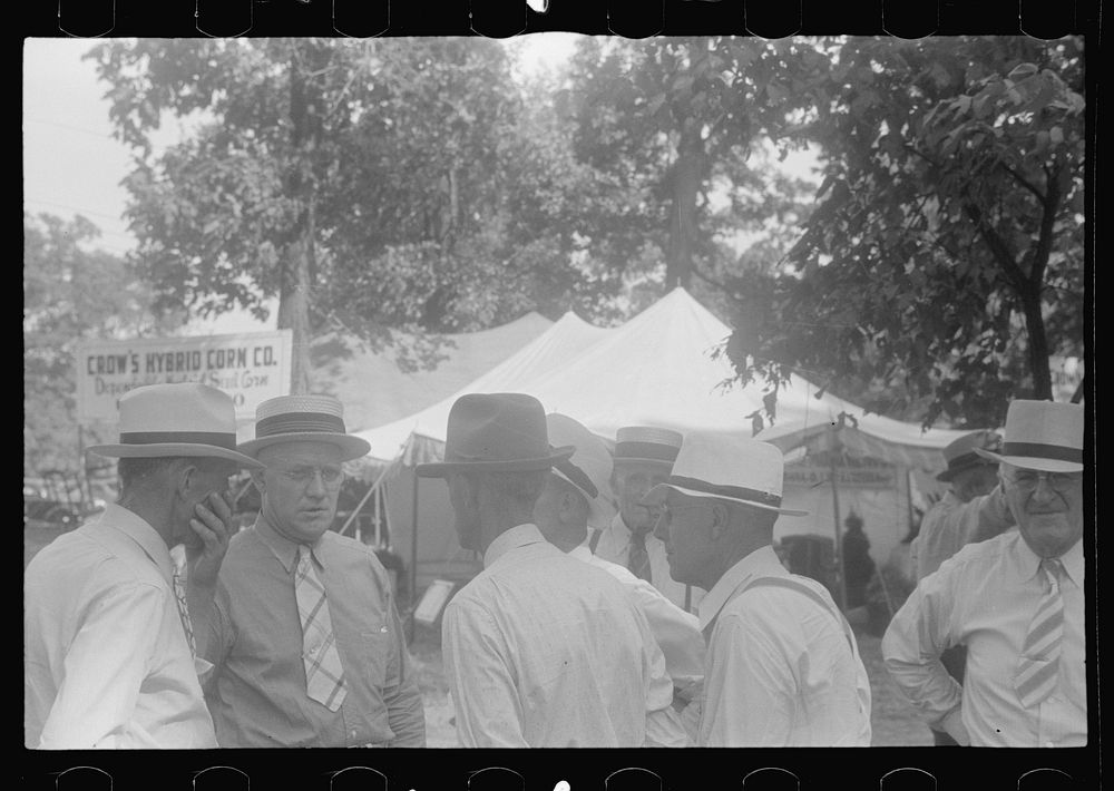 [Untitled photo, possibly related to: Farmers talking at county fair, central Ohio]. Sourced from the Library of Congress.