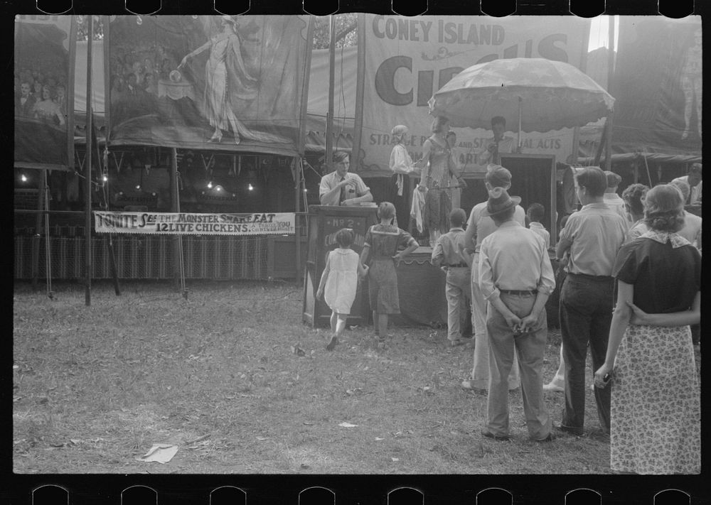 [Untitled photo, possibly related to: Selling tickets to the sideshow, county fair, central Ohio]. Sourced from the Library…