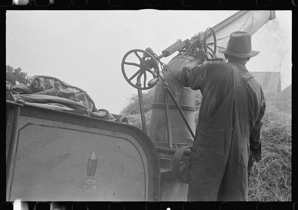 Adjusting straw stocker on grain separator, central Ohio. Sourced from the Library of Congress.