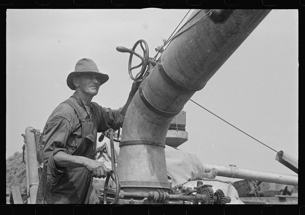 Adjusting straw stacker or grain separator, Ohio. Sourced from the Library of Congress.