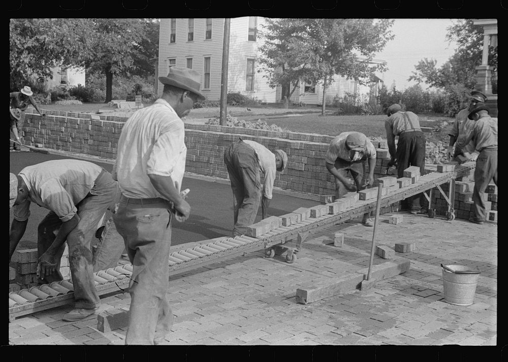Special laborsaving rollers used in moving brick for road repair, Route 40, central Ohio. Sourced from the Library of…
