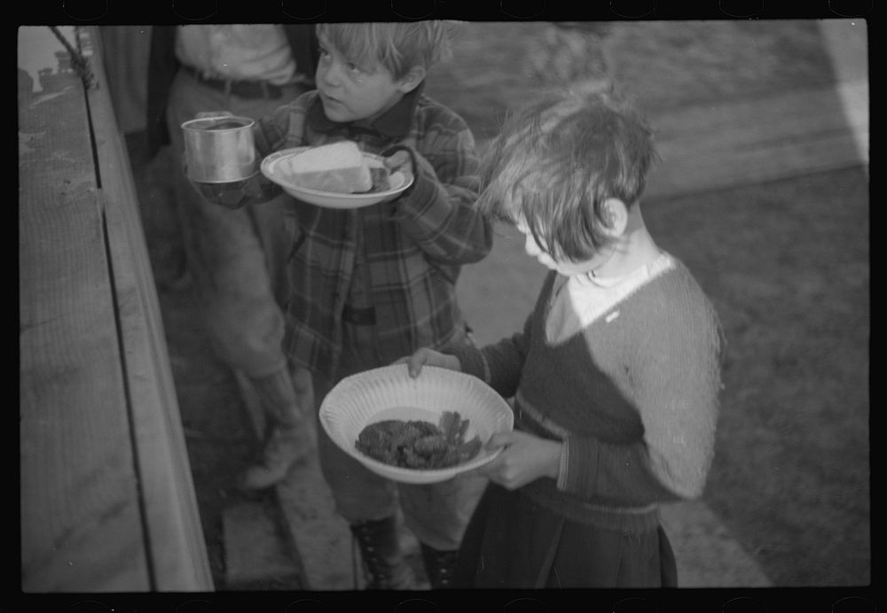 [Untitled photo, possibly related to: es in the lineup for food at mealtime in the camp for flood refugees, Forrest City…