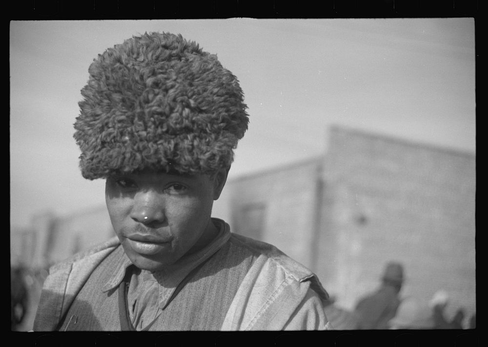  with a fur cap, a flood refugee in the camp at Forrest City, Arkansas. Sourced from the Library of Congress.
