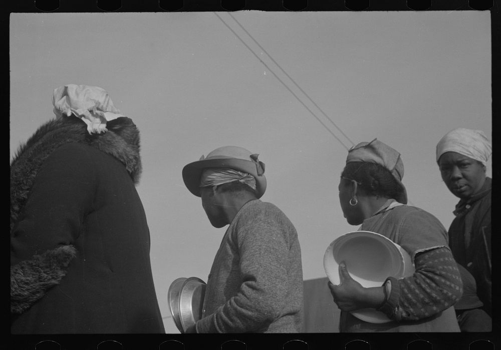 [Untitled photo, possibly related to: es in the lineup for food at meal time at the camp for flood refugees, Forrest City…