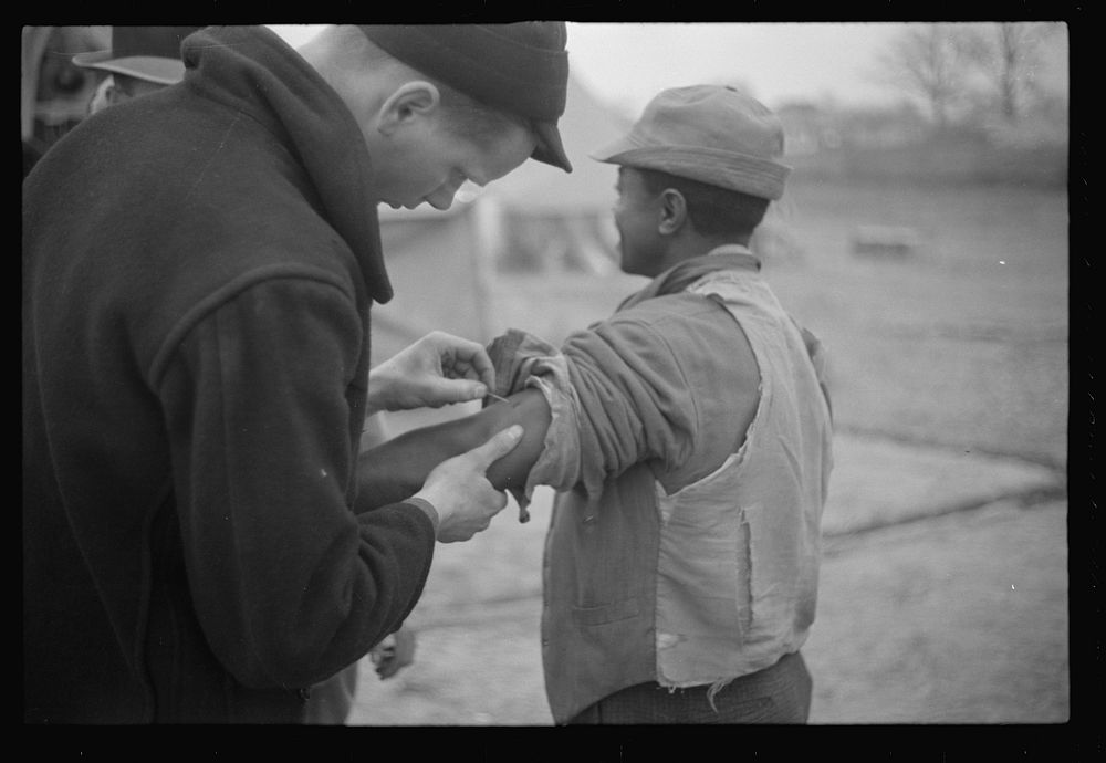 Vaccination in the camp for  flood refugees at Marianna, Arkansas. Sourced from the Library of Congress.