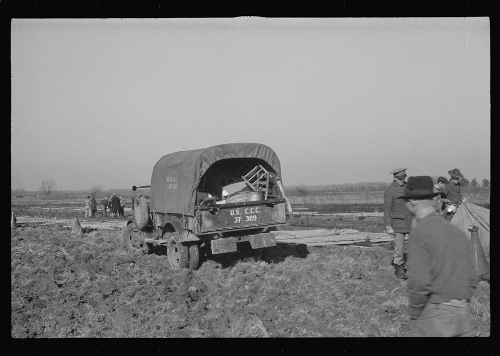 [Untitled photo, possibly related to: Unloading the household goods of a family who is being moved into the camp for white…