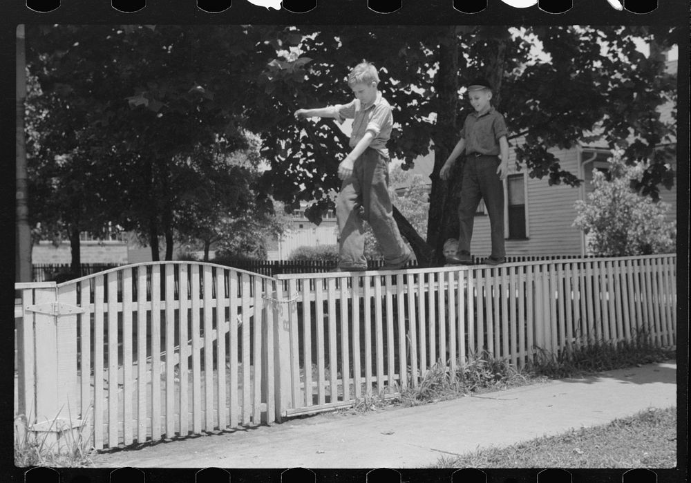Boys walking fence. Washington, Indiana. Sourced from the Library of Congress.