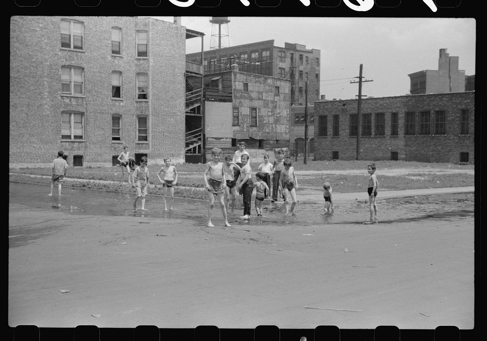 [Untitled photo, possibly related to: Cooling off in water from hydrant, Chicago, Illinois]. Sourced from the Library of…
