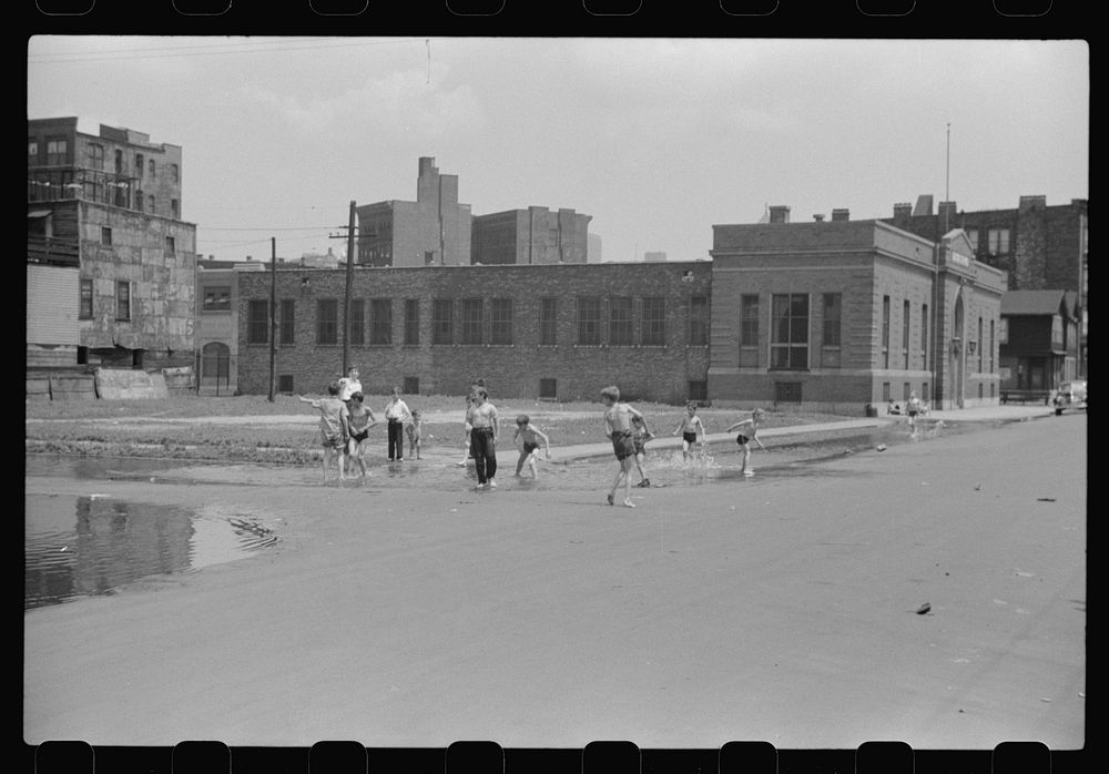 [Untitled photo, possibly related to: Cooling off in water from hydrant, Chicago, Illinois]. Sourced from the Library of…