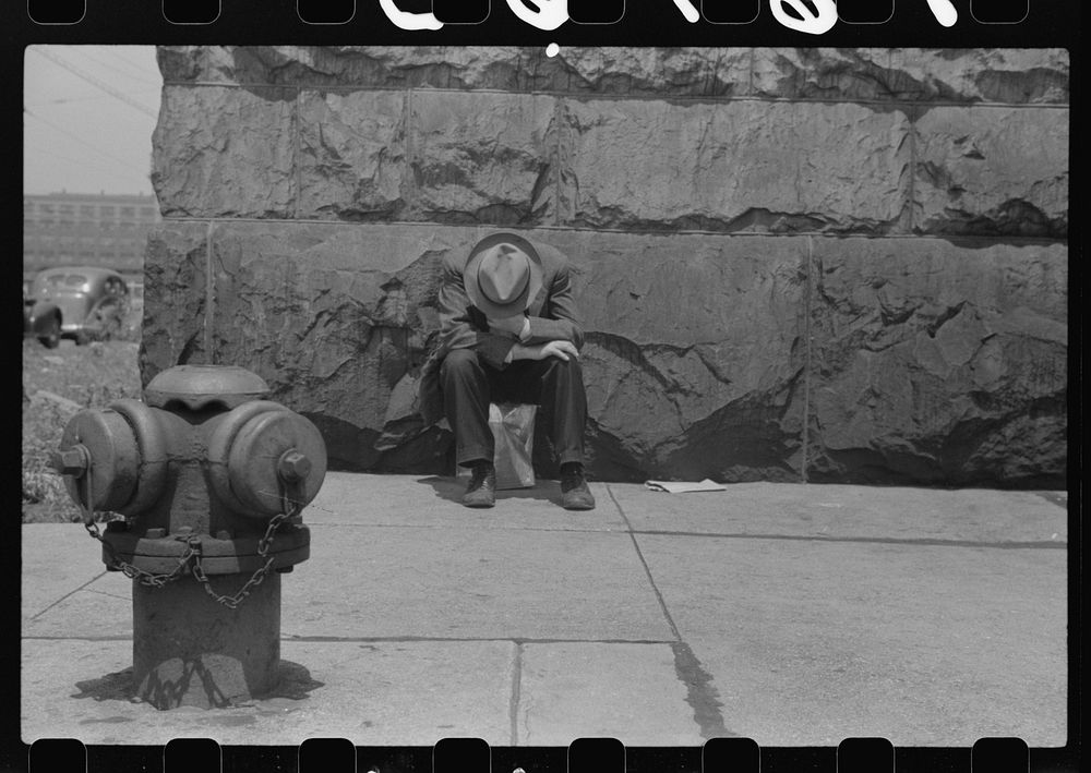 [Man seated on corner of Jefferson Street and Vernon Park Place, Chicago, Illinois]. Sourced from the Library of Congress.
