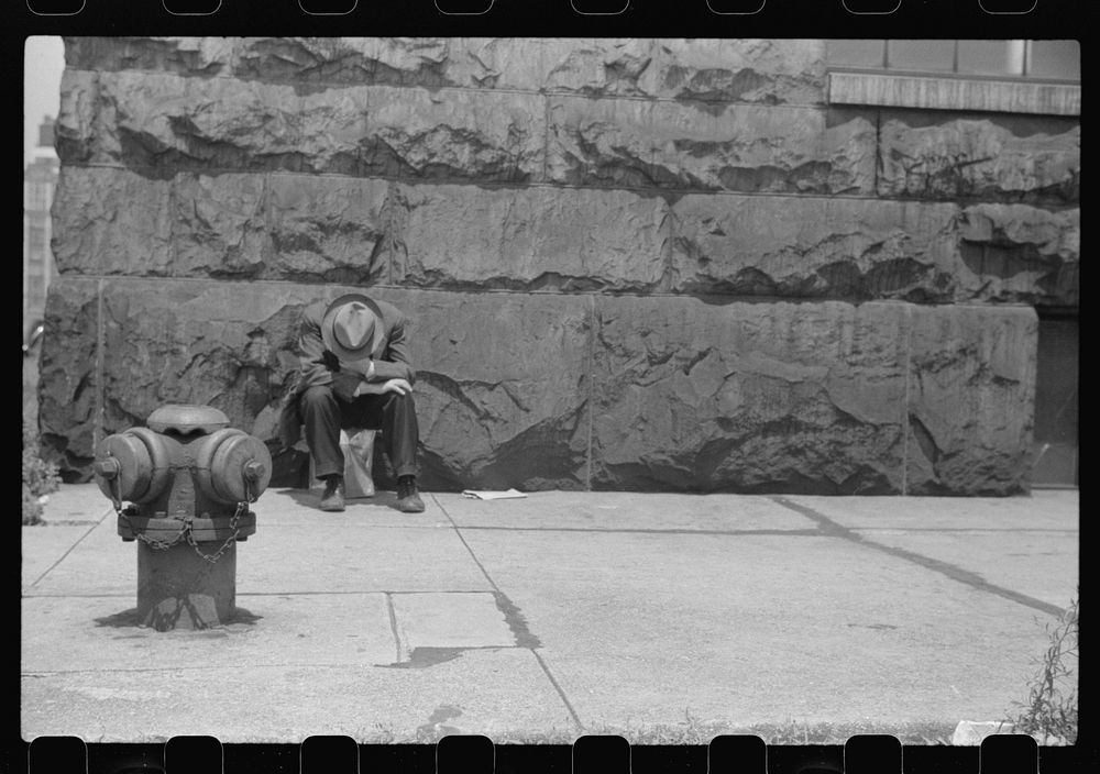 [Man seated on corner of Jefferson Street and Vernon Park Place,] Chicago, Illinois. Sourced from the Library of Congress.