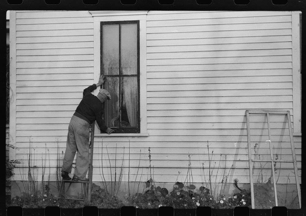 Putting up storm windows. Hillsboro, North Dakota. Sourced from the Library of Congress.