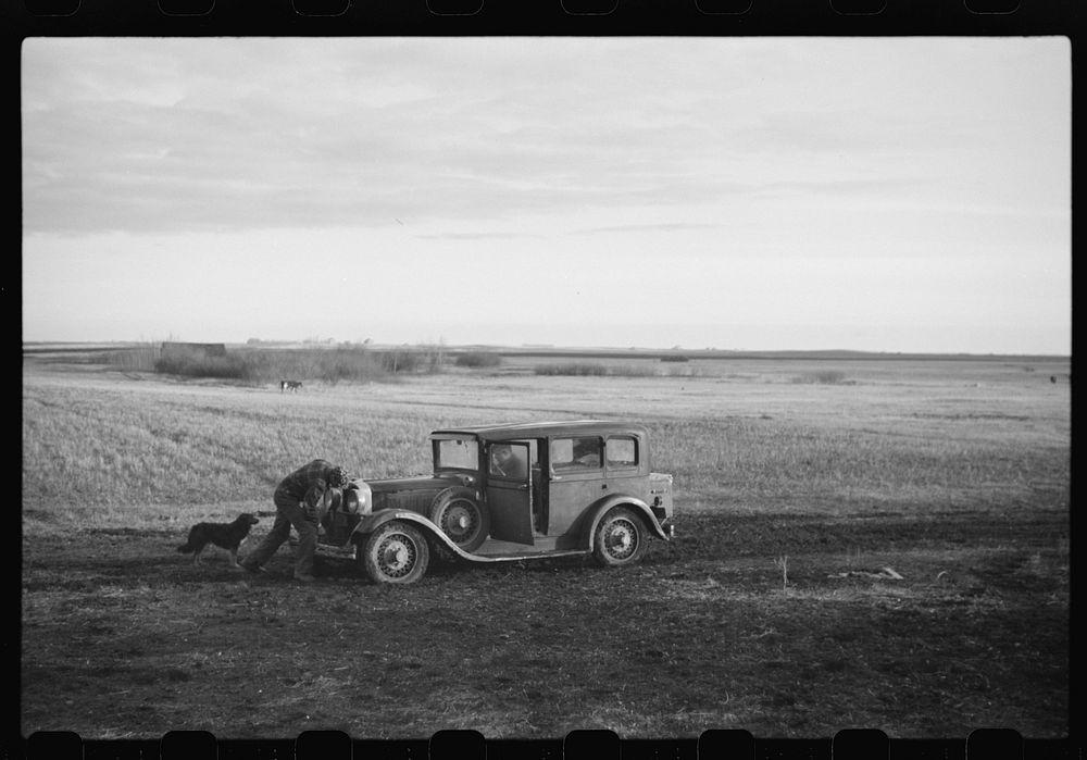 [Untitled photo, possibly related to: Oldest Sauer boy cranking family car. Cavalier County, North Dakota]. Sourced from the…