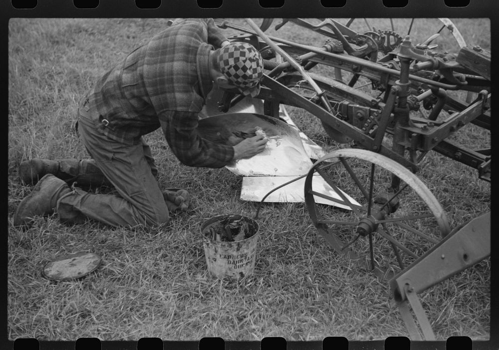 [Untitled photo, possibly related to: Greasing plow point for the winter. Cavalier County, North Dakota]. Sourced from the…