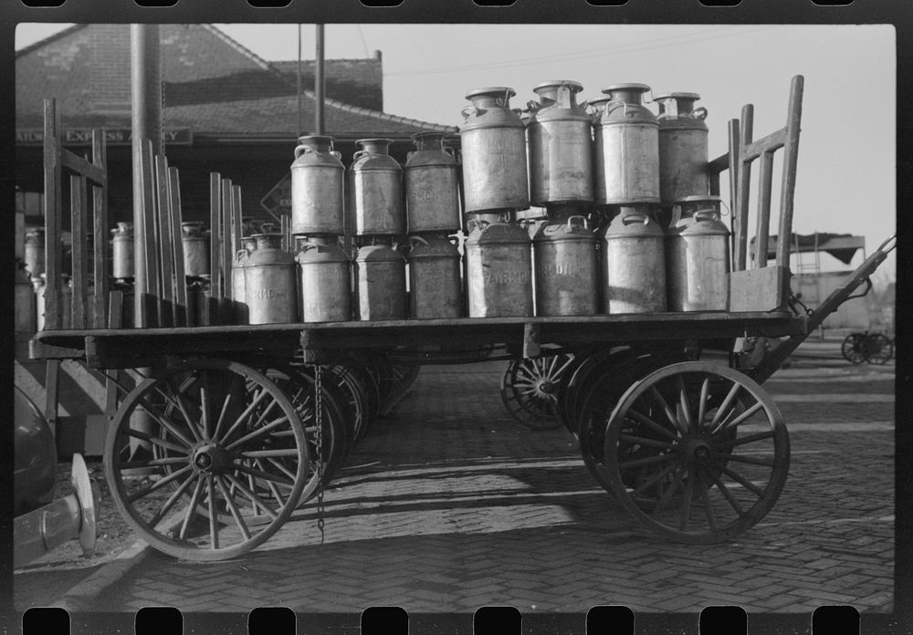 Milk cans at Railroad station. Minot, North Dakota. Sourced from the Library of Congress.