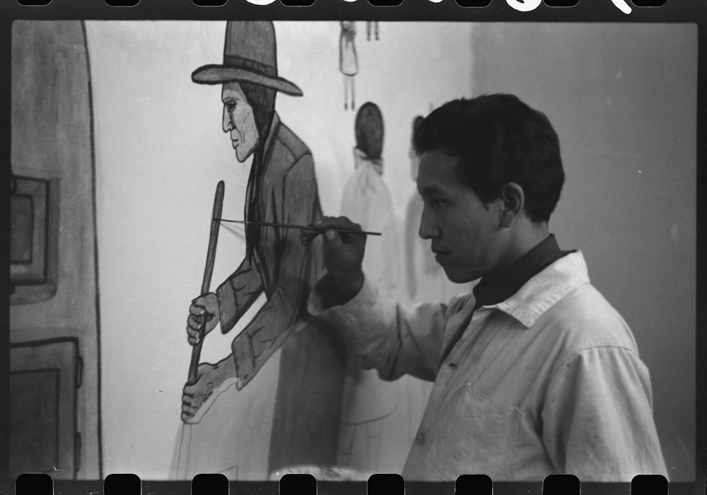 Andrew Standing Soldier, Sioux Indian, painting mural in auditorium, OD School, Pine Ridge, South Dakota. Sourced from the…