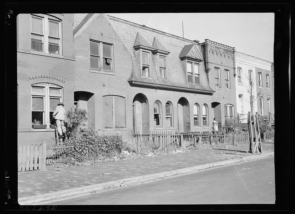View of "blight." This fine old brick dwelling is now a shambles, housing  families on relief. Washington, D.C.. Sourced…