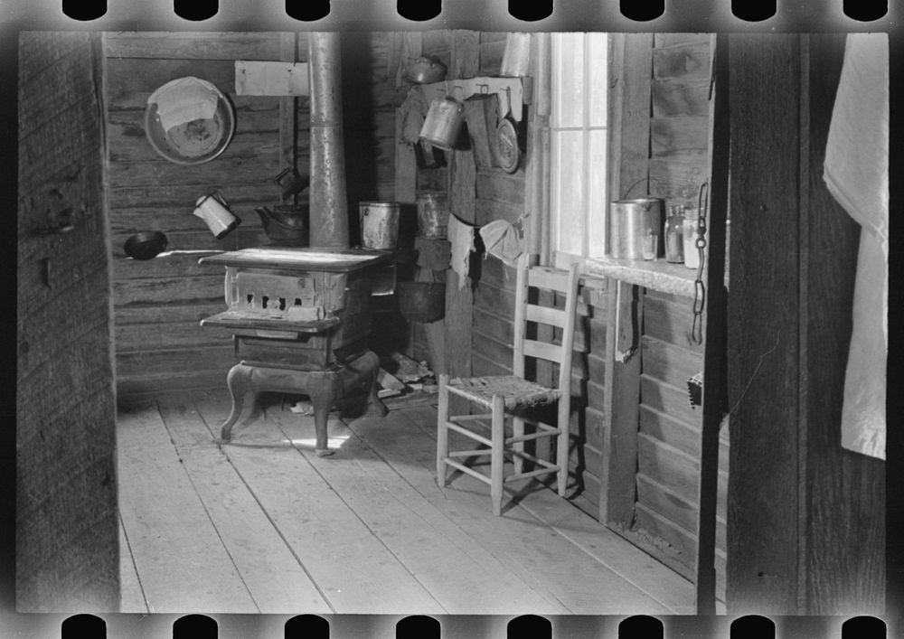 Kitchen in house of Floyd Burroughs, sharecropper, near Moundville, Hale County, Alabama. Sourced from the Library of…