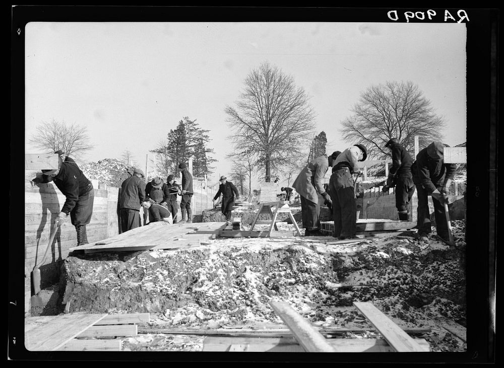 Work progresses on the first unit of houses despite the bad weather. Berwyn project, Maryland. Sourced from the Library of…
