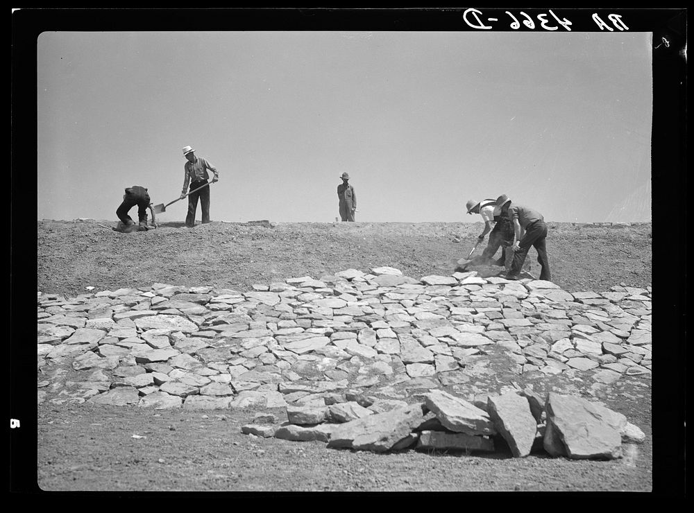 Working on the face of a stock water dam. Pine Ridge project, Sioux County, Nebraska. Sourced from the Library of Congress.