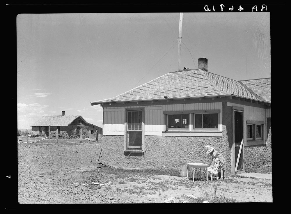 Old sod homestead in background. New house in foreground. Pennington County, South Dakota. Sourced from the Library of…