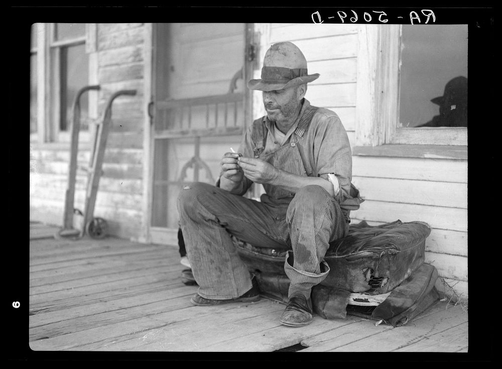 Waiting for better times, J. Huffman of Grassy Butte, North Dakota, sits in front of his closed store. Sourced from the…
