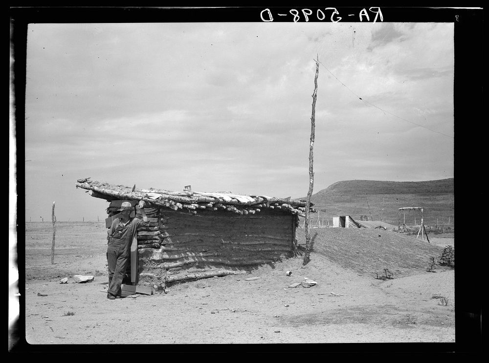 Dugout inhabited by farmers who have abandoned their farms and moved to town. Grassy Butte, North Dakota. Sourced from the…
