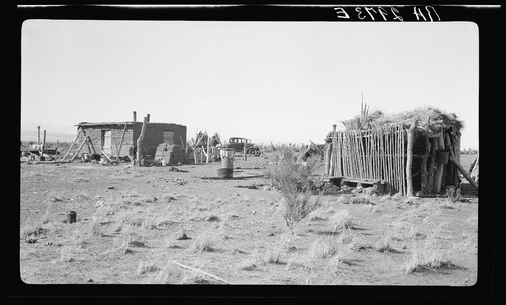 Houses formerly on land use project at Las Cruces, New Mexico. Note Mexican jacal at right. Sourced from the Library of…