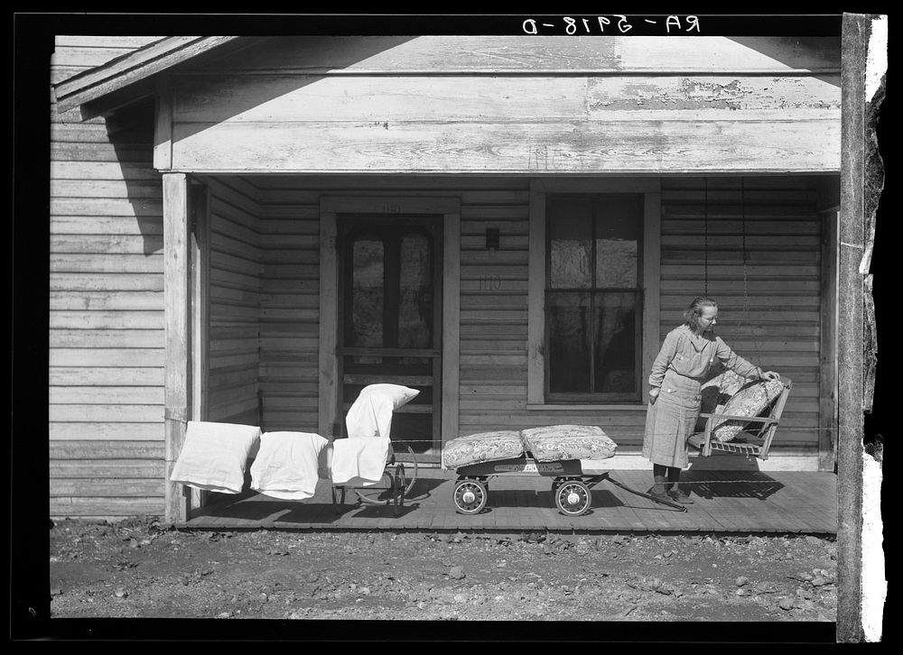 Mrs. Eargle of Fairfield airing her bedding preparatory to moving to her new home at Gardendale, Alabama. Sourced from the…
