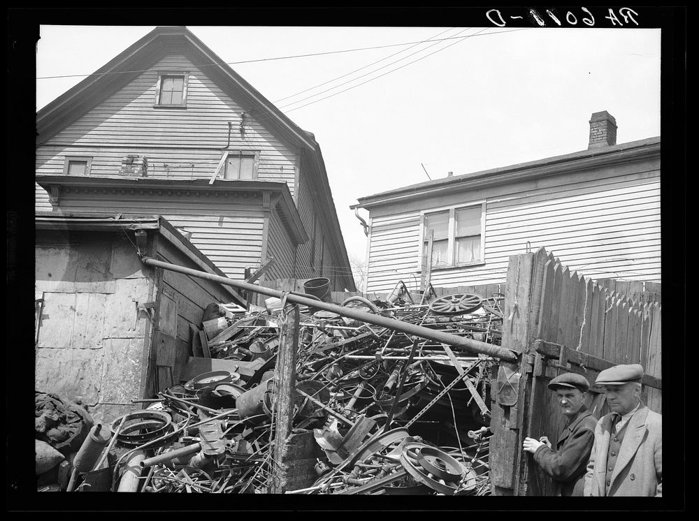 Close housing adjoining junk. Milwaukee, Wisconsin. Sourced from the Library of Congress.