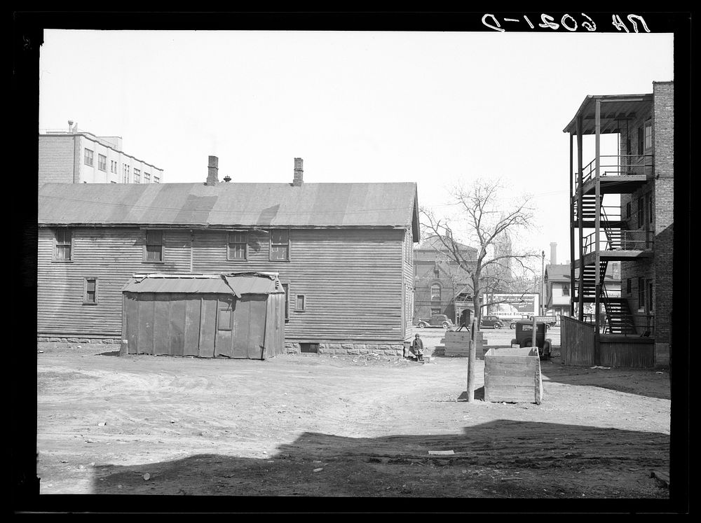 Exterior of house on alley between 7th and 8th and Milbourn and State Streets. Milwaukee, Wisconsin. Sourced from the…