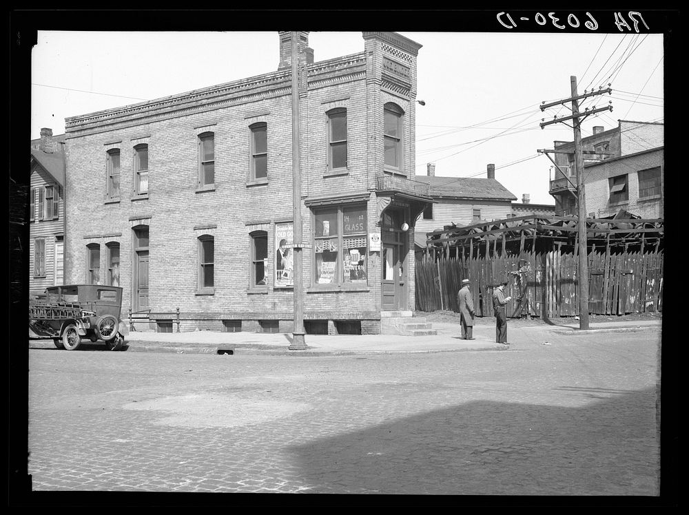 North 10th and McKinley Streets, house next to junk yard. Milwaukee, Wisconsin. Sourced from the Library of Congress.