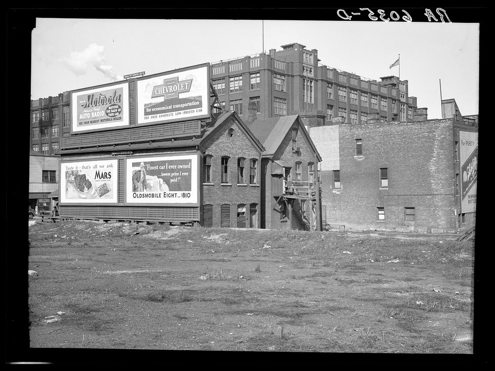 Rear of houses at 711 West State Street. Milwaukee Vocational School in background. Milwaukee, Wisconsin. Sourced from the…