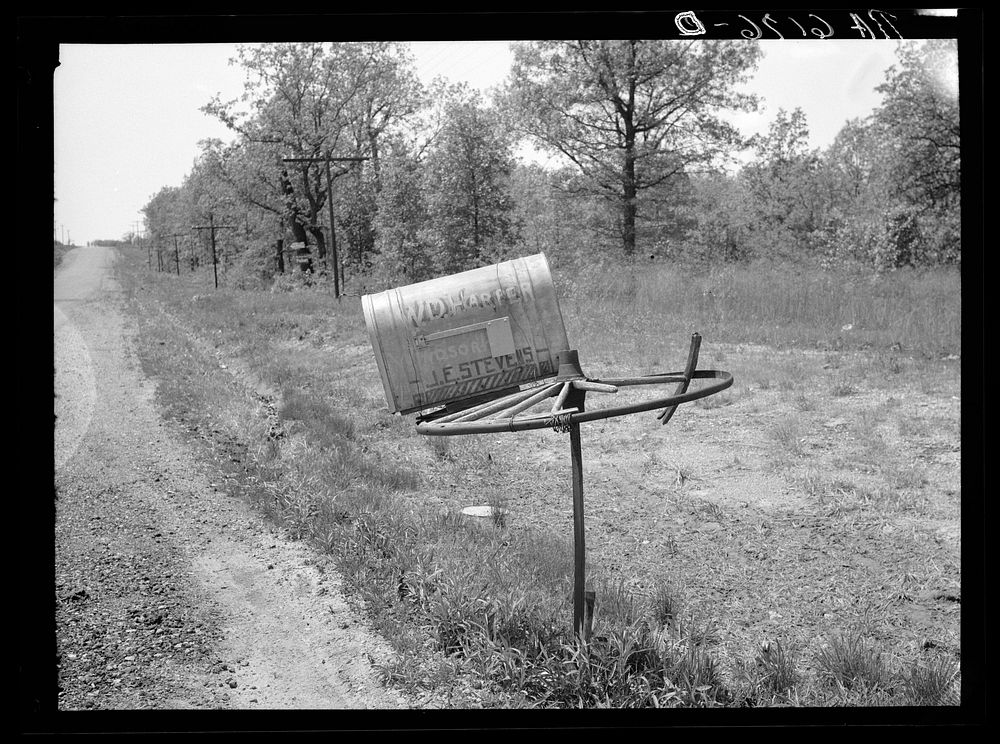 Rural mail box on old wagon wheel. Lake of the Ozarks, Missouri. Sourced from the Library of Congress.