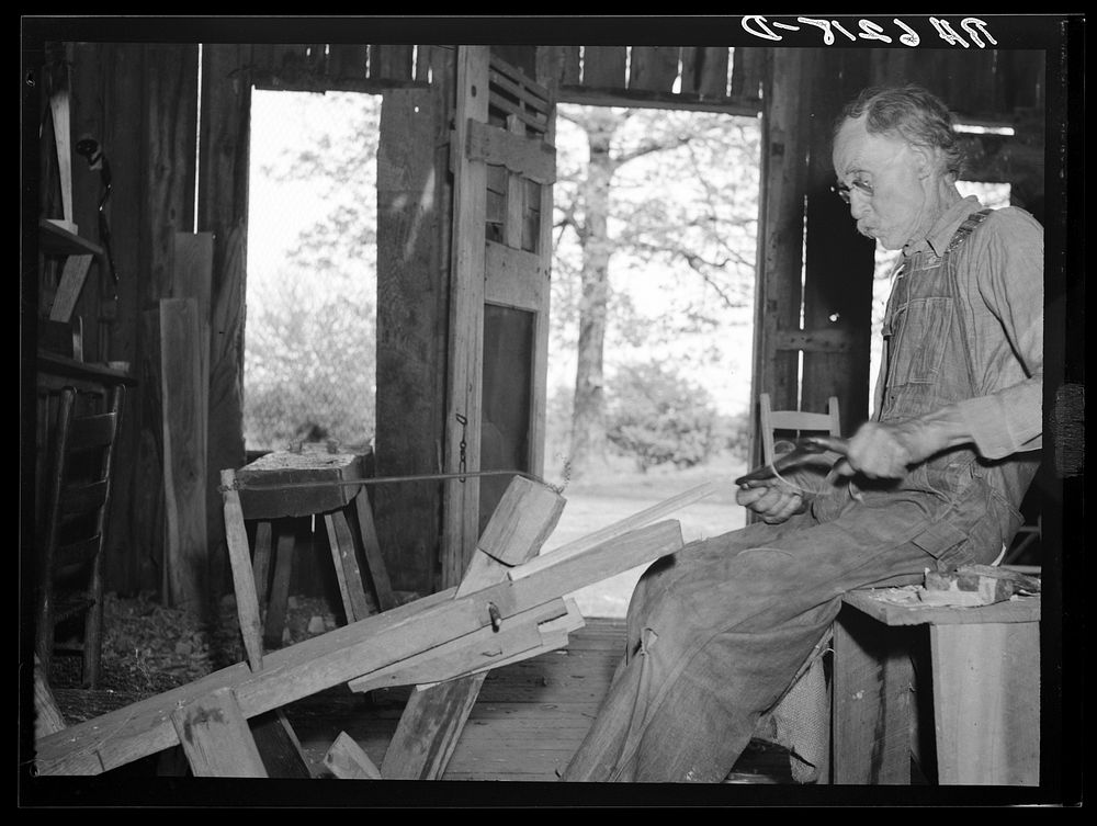 William Stamper, age eighty two, shaving oak sticks for chair braces in his workshop. Lake of the Ozarks passover area…
