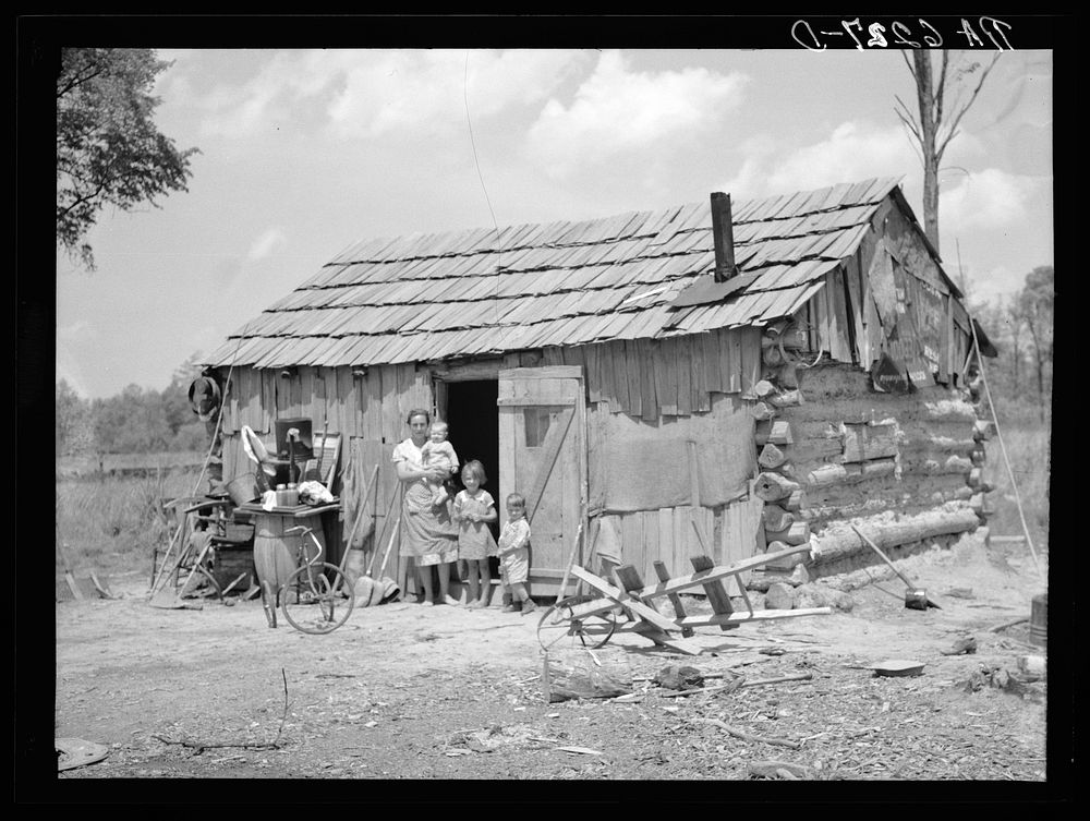 Portion of family of seven in their cabin on United States Highway No. 60 in southeastern Missouri. Sourced from the Library…