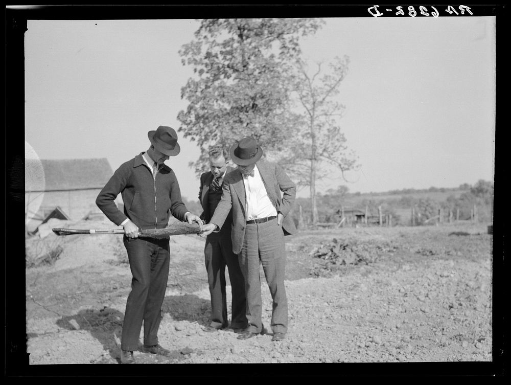 The Farm Security Administration supervisor shows the creditor the type of soil on the farm of the Farm Security…