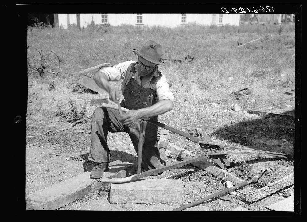 Repairing a plow on farm. Near West Memphis. Tennessee. Sourced from the Library of Congress.
