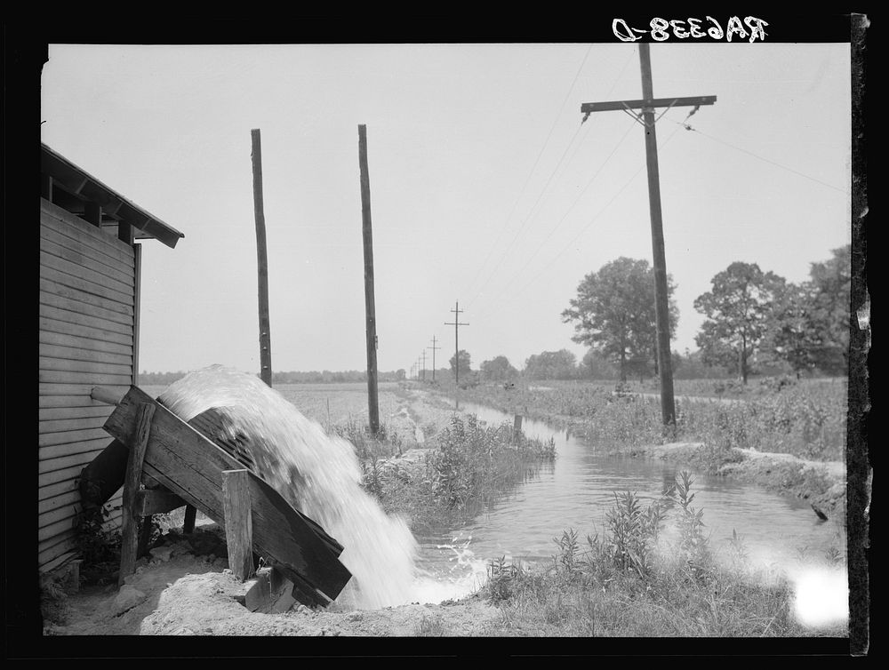 An electric pump, one of the newest type water pumps in Arkansas. Rice farming business near Harrisburg. This farm figures…